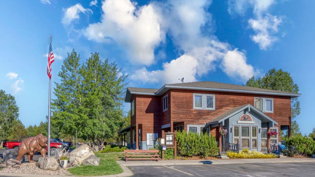 The office building at Yellowstone Grizzly RV Park under a blue sky