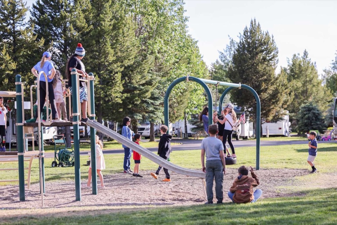 Families at the playground at Yellowstone Grizzly RV Park